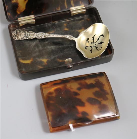 A tortoiseshell card case and a cigarette case and a sugar sifter spoon